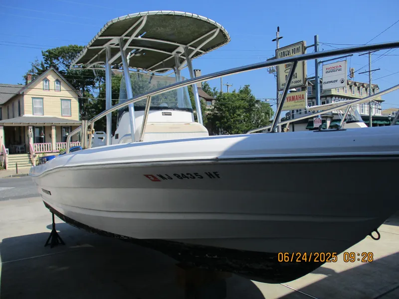 Slide: The Image of 2007 Triumph 21 Center Console boat on display at a marina. - 13