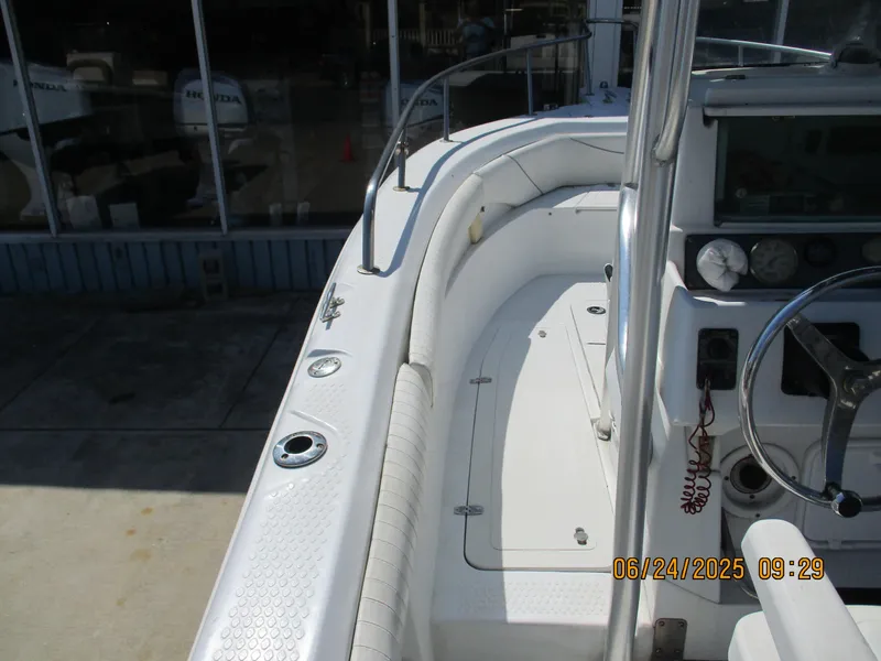 Slide: The Image of 2007 Triumph 21 Center Console boat interior with steering wheel and seating area. - 17