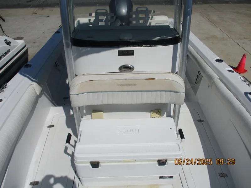 Slide: The Image of 2007 Triumph 21 Center Console boat interior with seating and cooler. - 19
