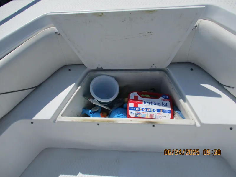 Slide: The Image of 2007 Triumph 21 Center Console storage with first aid kit and boating essentials. - 23