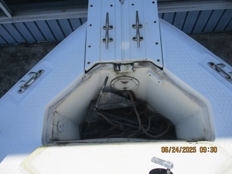 Slide: The Image of 2007 Triumph 21 Center Console boat anchor storage compartment with rope. - 24