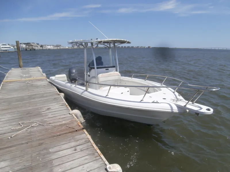Slide: The Image of 2007 Triumph 21 Center Console boat docked on a sunny day. - 4
