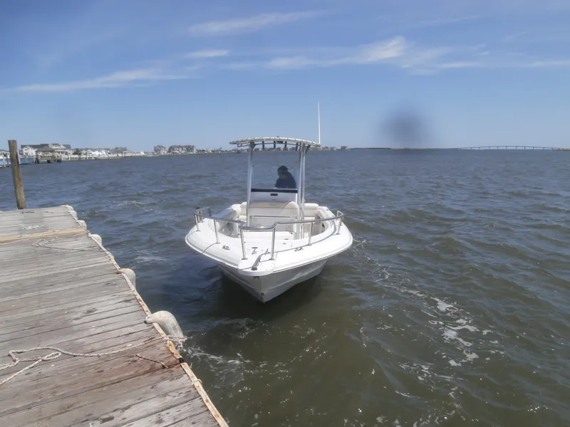 Slide: The Image of 2007 Triumph 21 Center Console boat approaching dock on a sunny day. - 5