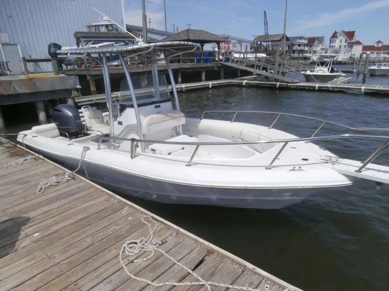 Slide: The Image of 2007 Triumph 21 Center Console boat docked at a marina. - 6