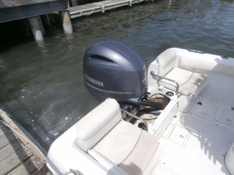 Slide: The Image of 2007 Triumph 21 Center Console boat with Yamaha outboard motor docked by water. - 7