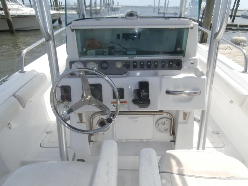 Slide: The Image of 2007 Triumph 21 Center Console boat dashboard with steering wheel and controls. - 8
