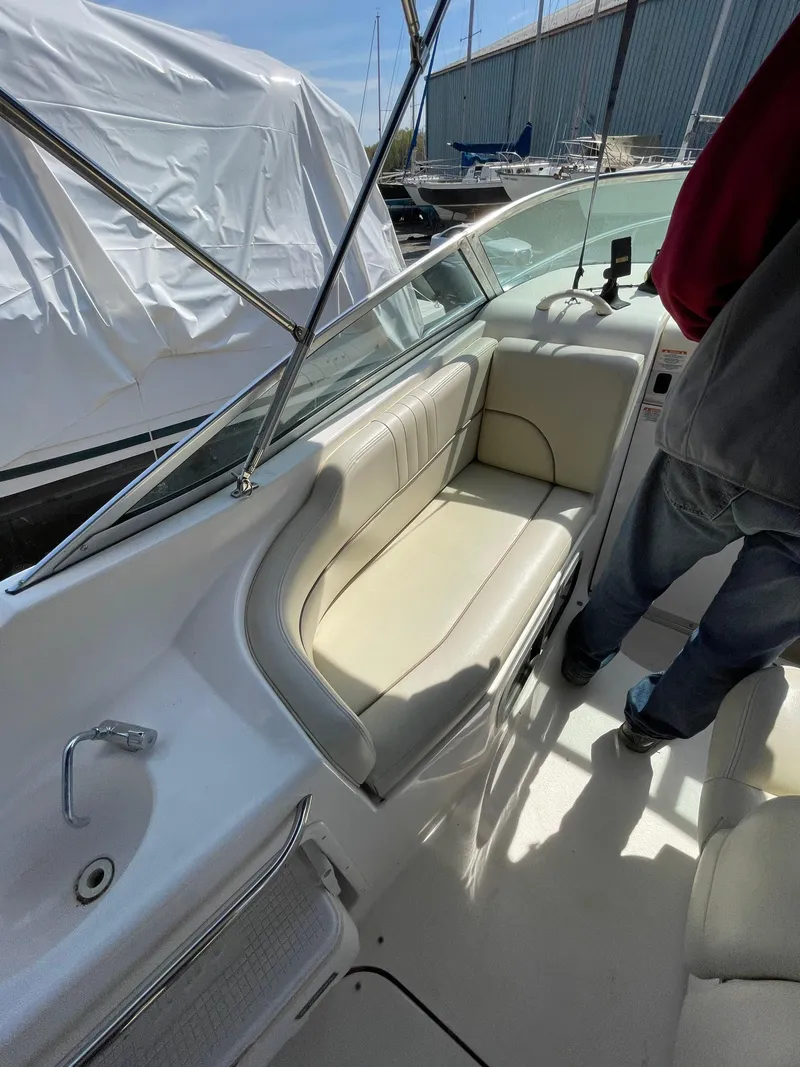 Slide: The Image of 2004 Chaparral Signature 240 boat interior with seating and sink, docked in a marina. - 10