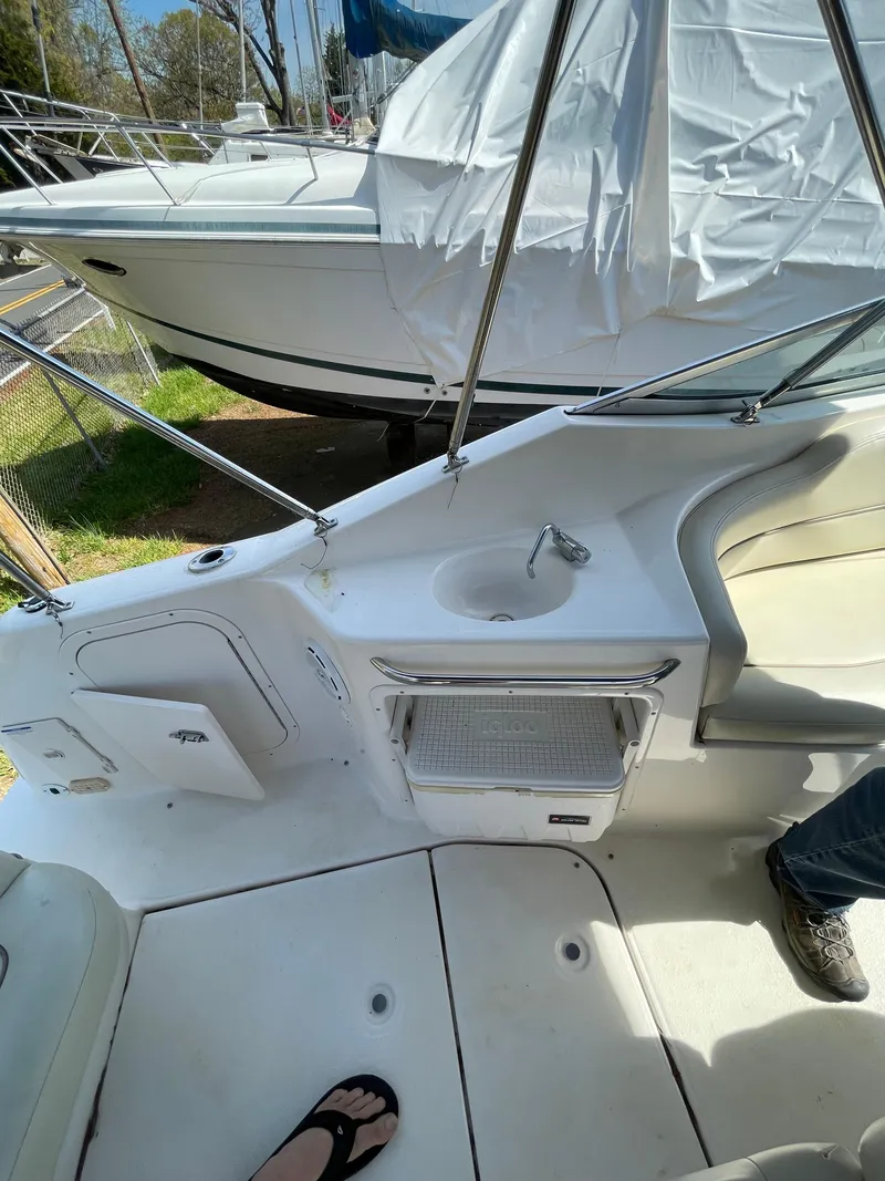 Slide: The Image of 2004 Chaparral Signature 240 boat interior with seating and sink. - 11