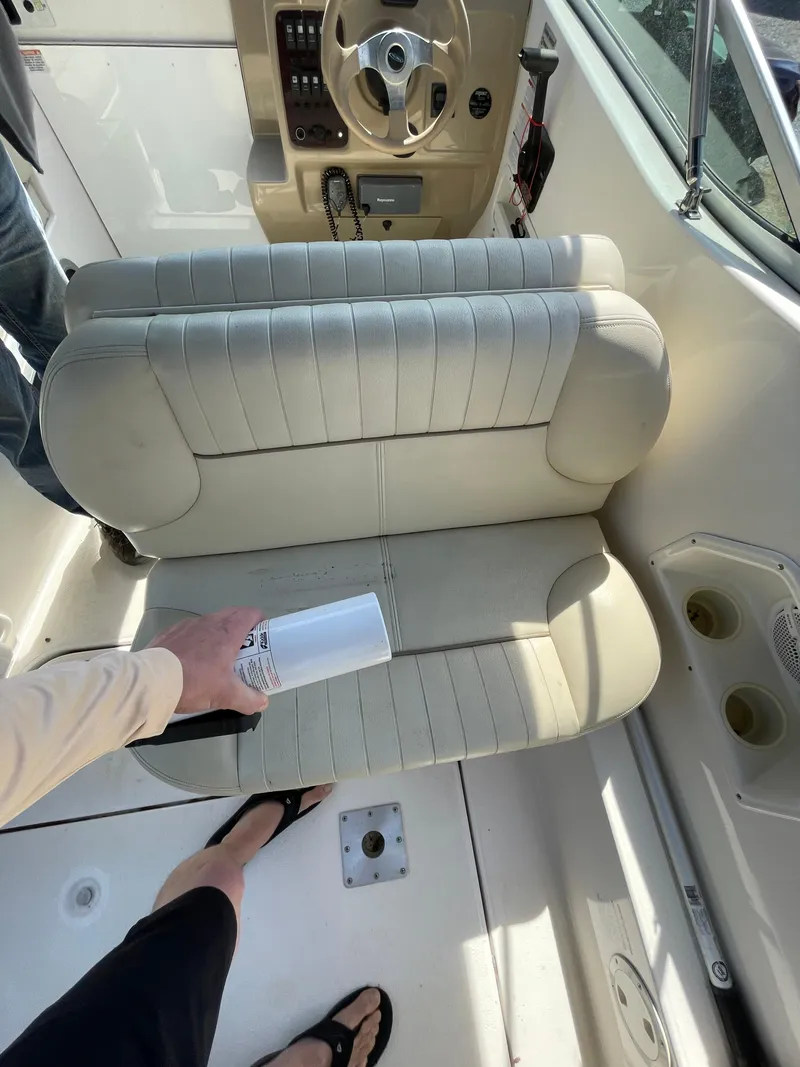 Slide: The Image of 2004 Chaparral Signature 240 boat interior with beige seating and steering console. - 12