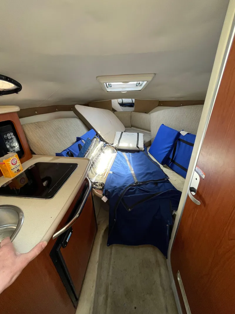 Slide: The Image of Interior of 2004 Chaparral Signature 240 boat with kitchenette and seating area. - 14