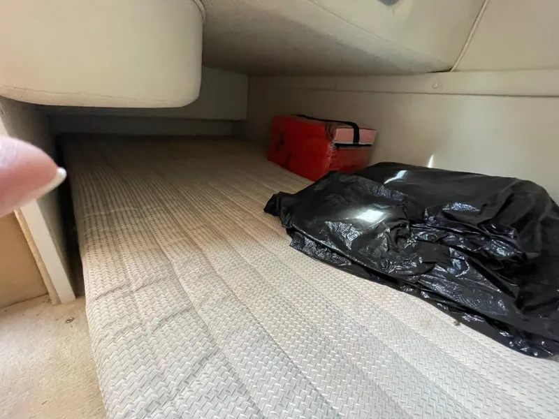 Slide: The Image of Interior cabin of 2004 Chaparral Signature 240 boat with storage items. - 15
