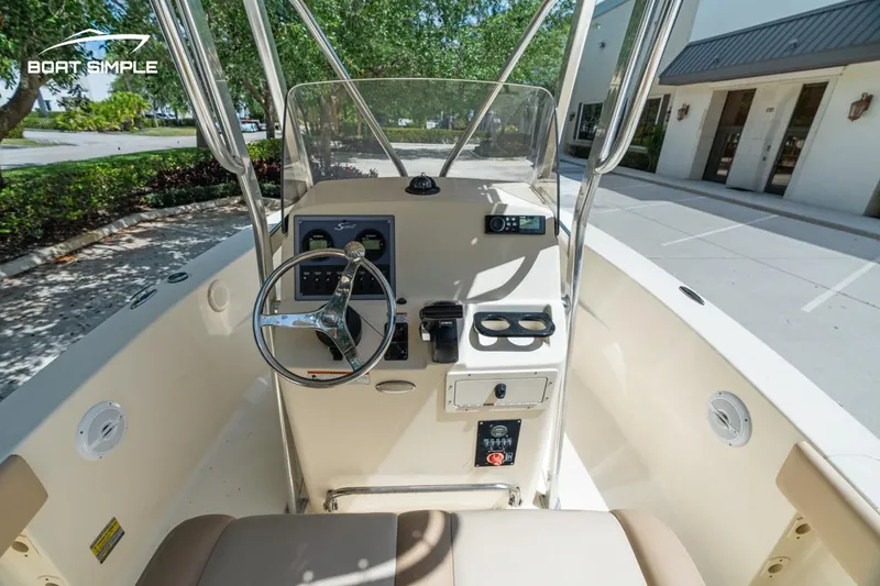 Slide: The Image of 2022 Scout 195 Sportfish boat console with steering wheel and controls. - 9