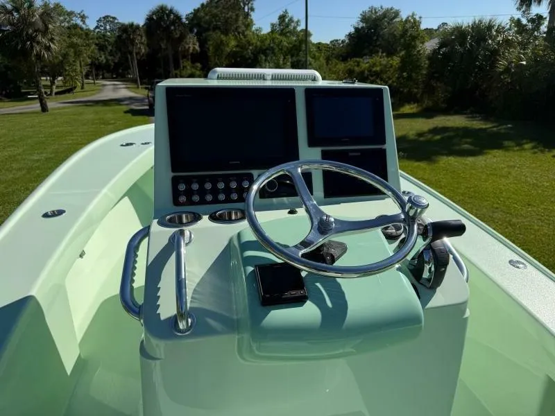 Slide: The Image of Custom Vernese V23 boat dashboard with steering wheel and dual screens, 2021 model. - 10