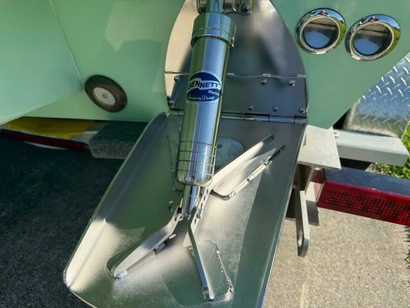 Slide: The Image of Boat trim tab system on a 2021 Custom Vernese V23, featuring Bennett Marine components. - 11