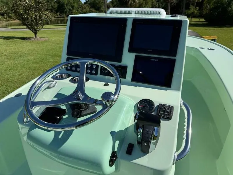 Slide: The Image of Custom Vernese V23 boat dashboard with steering wheel and digital displays, 2021 model. - 12