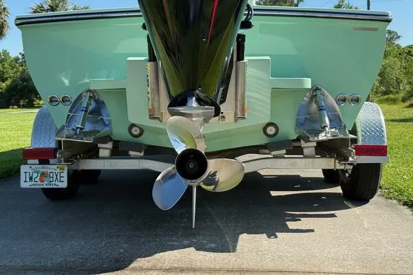 Slide: The Image of Rear view of a 2021 Custom Vernese V23 boat on a trailer, showcasing the propeller. - 14