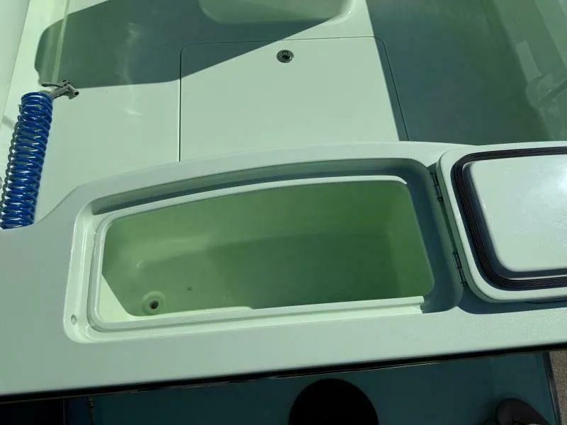 Slide: The Image of Open storage compartment on a 2021 Custom Vernese V23 boat, featuring a sleek design. - 17