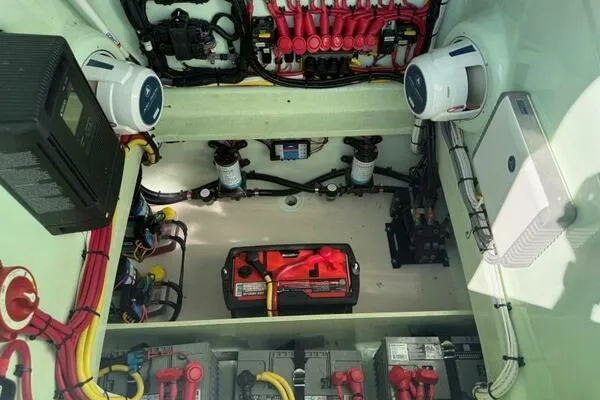 Slide: The Image of Engine compartment of a 2021 Custom Vernese V23, showcasing wiring and battery setup. - 20