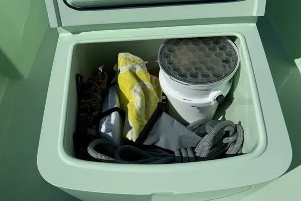 Slide: The Image of Storage compartment in Custom Vernese V23 boat, containing ropes and gear, 2021 model. - 23