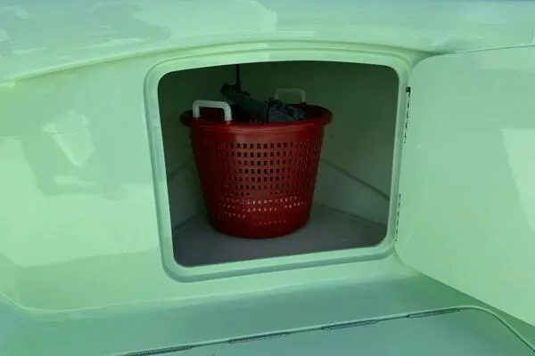 Slide: The Image of Red basket inside storage compartment of Custom Vernese V23, 2021 model. - 26