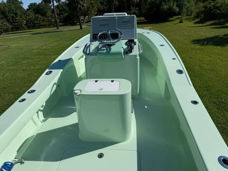 Slide: The Image of Custom Vernese V23 boat, 2021 model, with sleek design and modern controls on grassy background. - 3