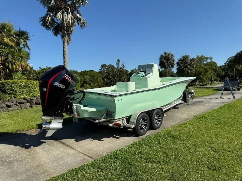 Slide: The Image of Custom Vernese V23 boat on trailer, 2021 model, parked on sunny driveway. - 6