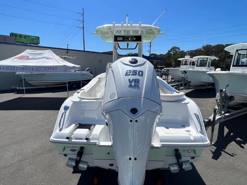 Slide: The Image of 2025 Sea Hunt Ultra 235 SE boat displayed outdoors on a sunny day. - 3