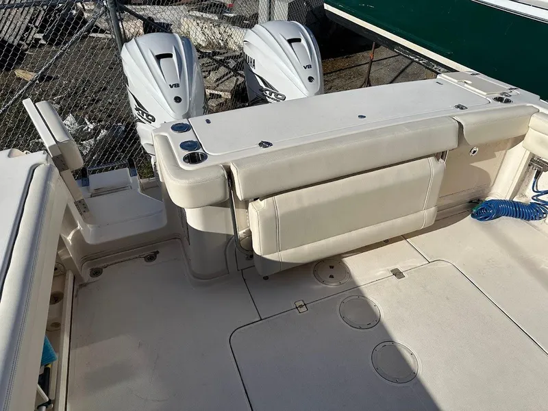 Slide: The Image of 2022 Grady-White Express 330 boat deck with dual outboard engines. - 12