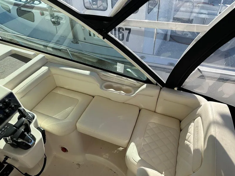 Slide: The Image of 2022 Grady-White Express 330 interior with cream seating and modern controls. - 18