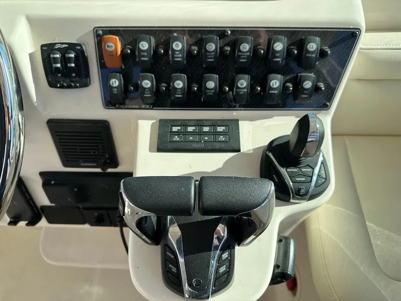 Slide: The Image of Control panel of 2022 Grady-White Express 330 boat with switches and throttle. - 21