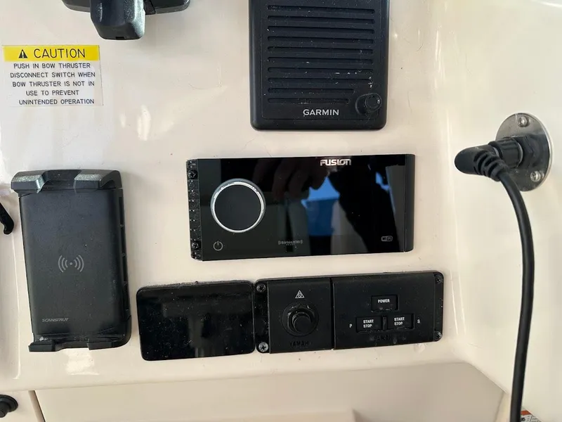 Slide: The Image of Control panel of 2022 Grady-White Express 330 with Garmin and Fusion devices. - 23