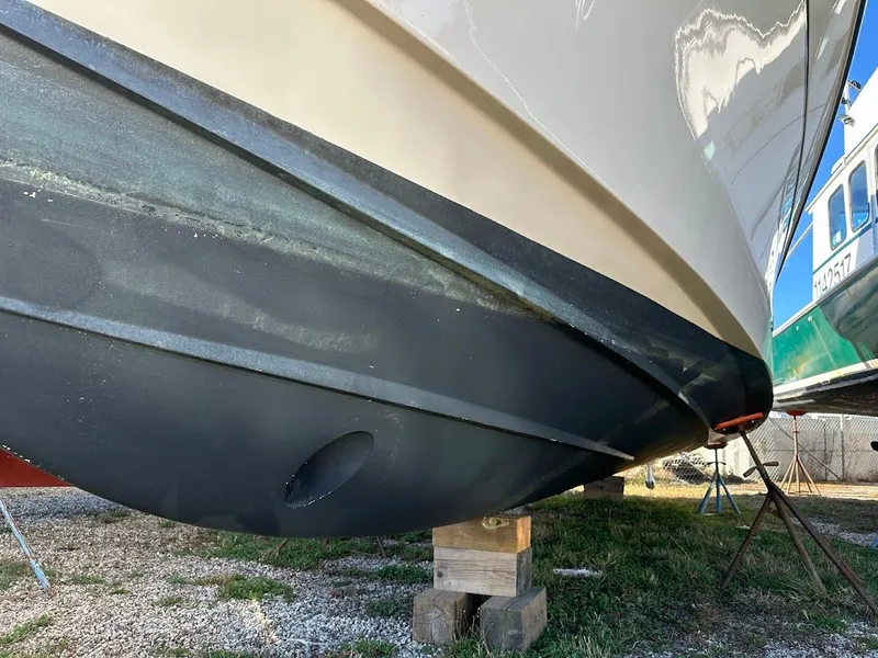 Slide: The Image of 2022 Grady-White Express 330 boat hull on dry dock, side view. - 3