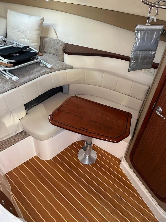 Slide: The Image of 2022 Grady-White Express 330 cabin interior with wood table and seating. - 33