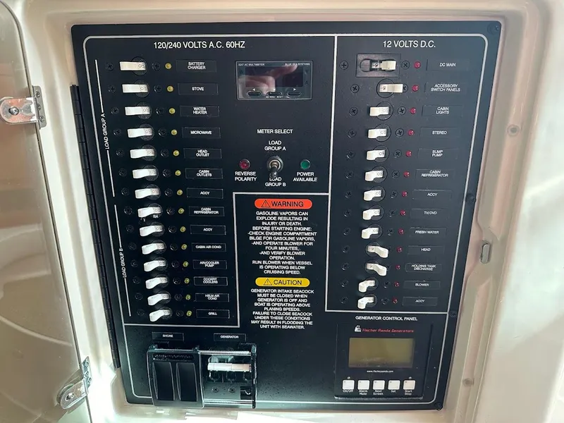 Slide: The Image of Electrical control panel on 2022 Grady-White Express 330 boat, showing AC and DC switches. - 36