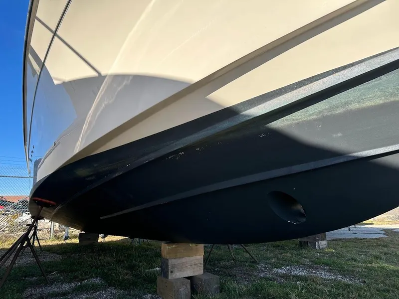 Slide: The Image of 2022 Grady-White Express 330 boat hull on stands, side view. - 4