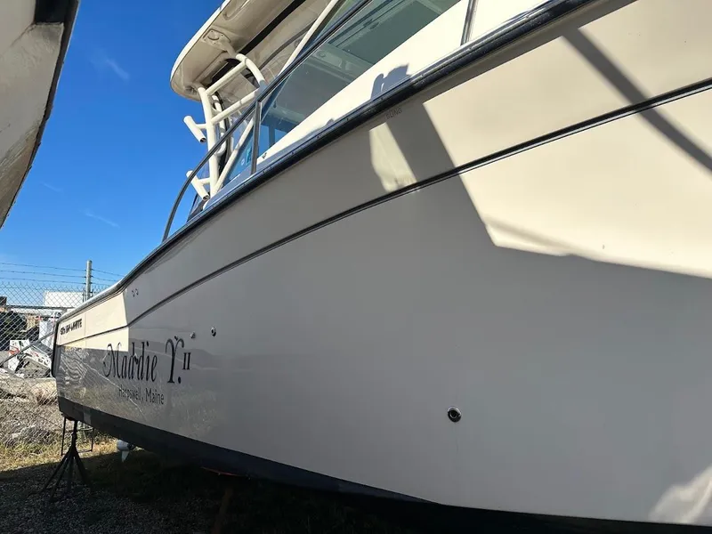 Slide: The Image of 2022 Grady-White Express 330 boat docked, side view under clear blue sky. - 5