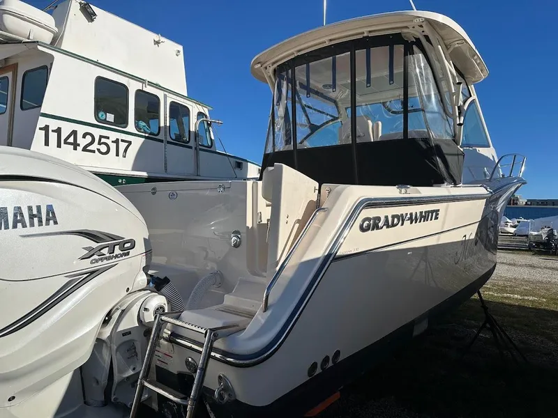 Slide: The Image of 2022 Grady-White Express 330 boat with Yamaha XTO engine, docked outdoors. - 6