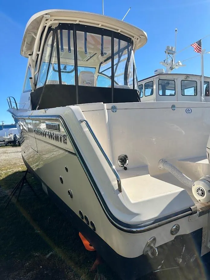 Slide: The Image of 2022 Grady-White Express 330 boat, docked, rear view with clear skies. - 7