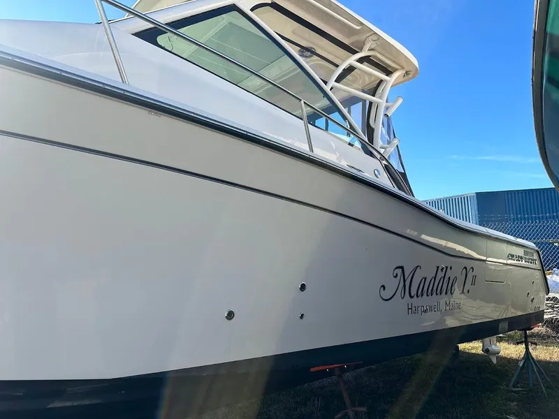 Slide: The Image of 2022 Grady-White Express 330 boat docked under clear blue sky. - 8