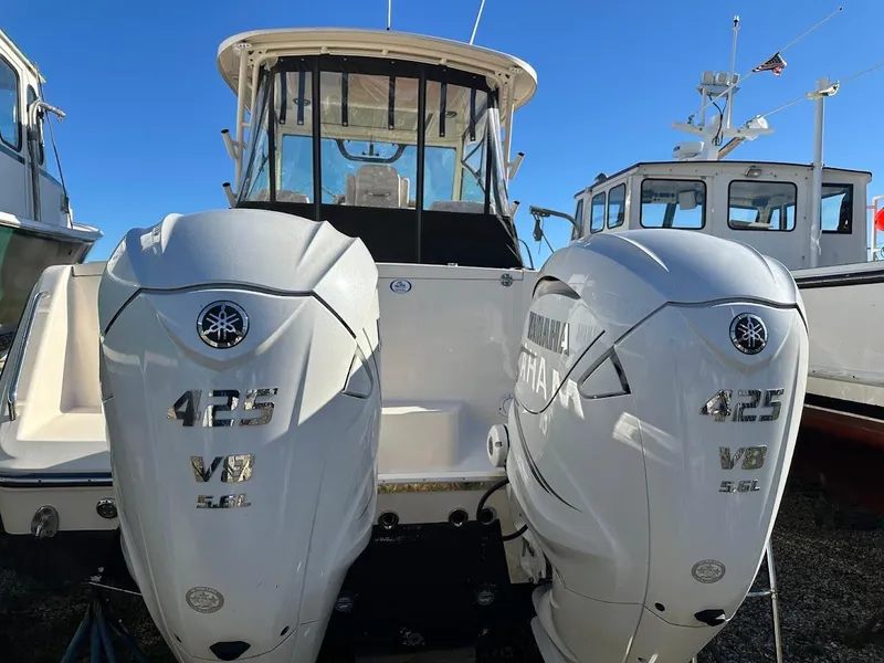 Slide: The Image of 2022 Grady-White Express 330 with twin Yamaha 425 V8 engines, docked under clear skies. - 9