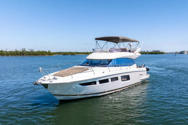 Slide: The Image of 2012 Prestige 500 Fly yacht cruising on a serene blue waterway. - 1