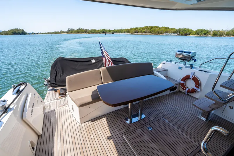 Slide: The Image of Prestige 500 Fly 2012 yacht deck with seating, table, and scenic water view. - 13