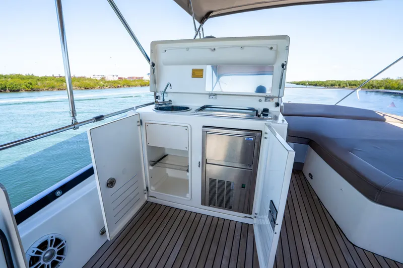 Slide: The Image of Prestige 500 Fly 2012 yacht with outdoor kitchenette and seating area on deck. - 23