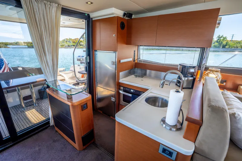 Slide: The Image of Luxurious interior of 2012 Prestige 500 Fly yacht with modern kitchen and scenic water view. - 26