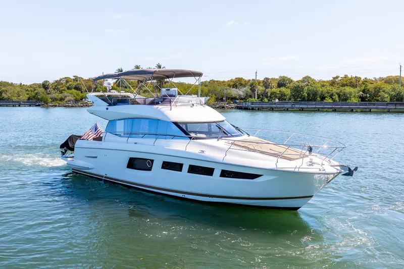 Slide: The Image of 2012 Prestige 500 Fly yacht cruising on a sunny day, featuring sleek design and spacious flybridge. - 3