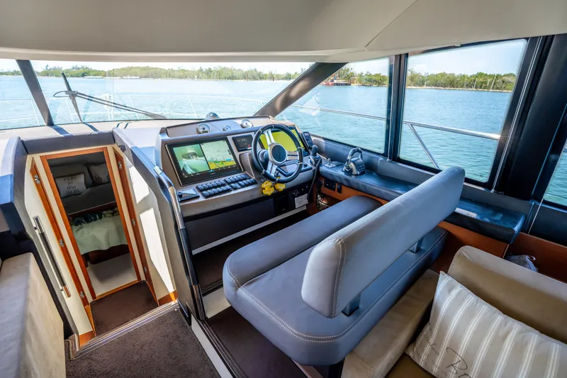 Slide: The Image of Interior of 2012 Prestige 500 Fly yacht with modern helm and scenic water view. - 38