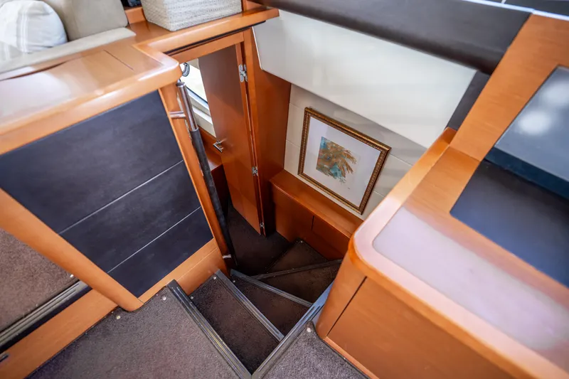 Slide: The Image of Interior stairs of 2012 Prestige 500 Fly yacht, featuring wood finish and framed artwork. - 41