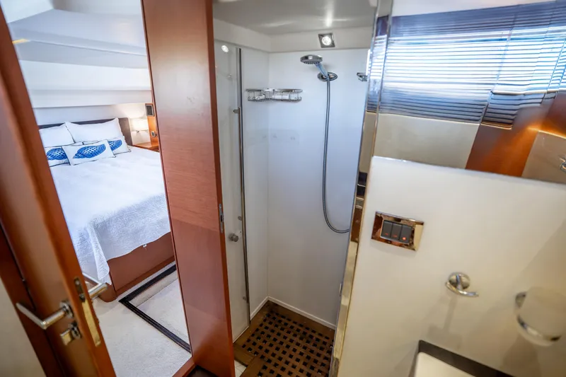 Slide: The Image of Interior of 2012 Prestige 500 Fly yacht showing bedroom and bathroom with shower. - 48