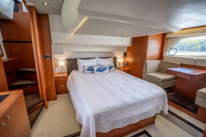 Slide: The Image of Luxurious cabin interior of a 2012 Prestige 500 Fly yacht with a cozy bed and seating area. - 49