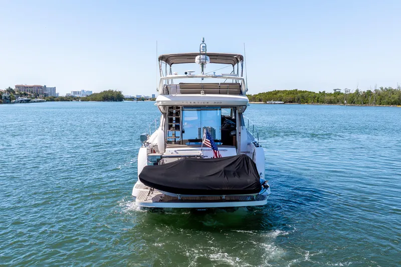 Slide: The Image of 2012 Prestige 500 Fly yacht cruising on a serene waterway. - 5